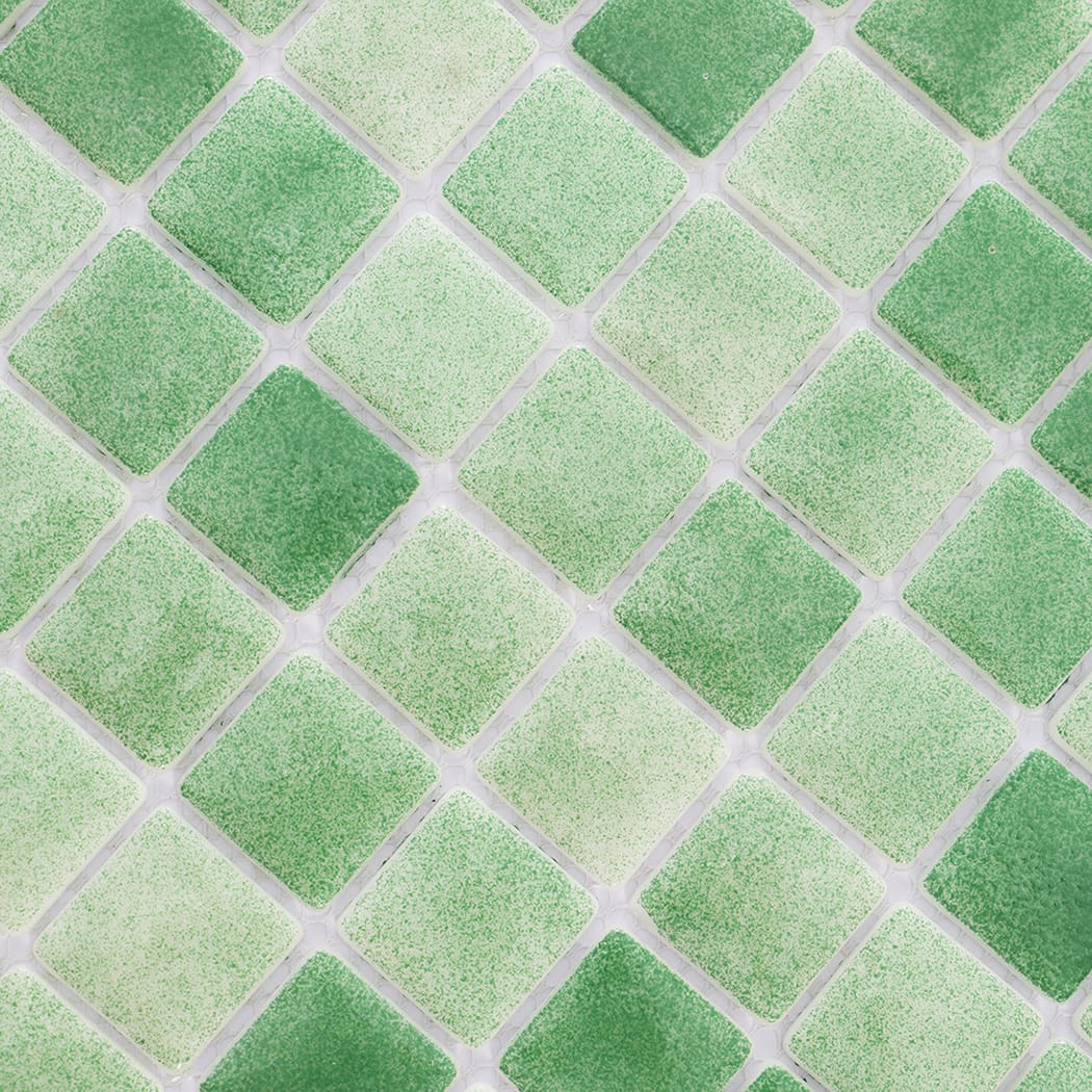 Close-up view of green recycled glass mosaic tiles with subtle color variation.