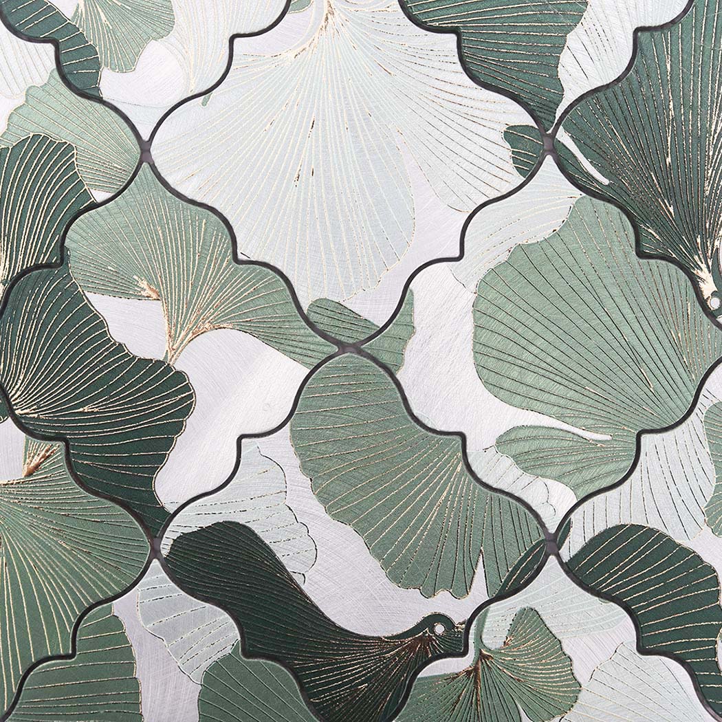 Close-up of green and silver floral aluminum mosaic tile with engraved botanical pattern