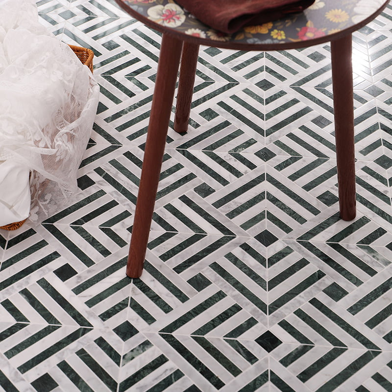 Close-up of geometric green and white marble mosaic tile design, highlighting intricate patterns.