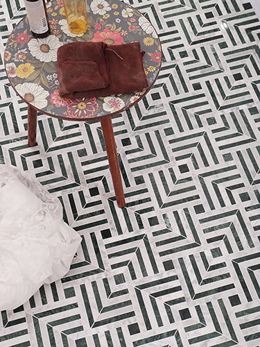  Green and white marble tile featuring a geometric pattern with deep green and white accents. 