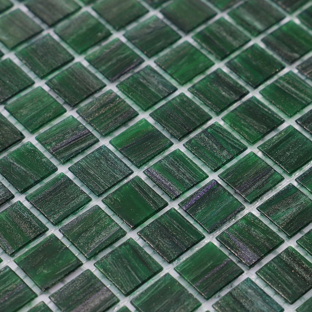 Close up of green mosaic tile surface showing shimmer and fine texture