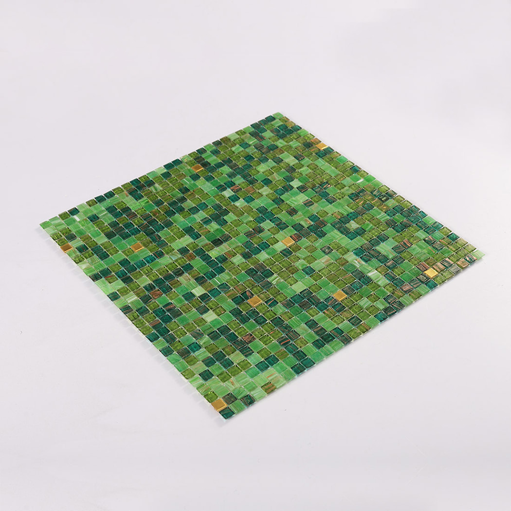 Angled view of a green glass mosaic tile sheet on a white background