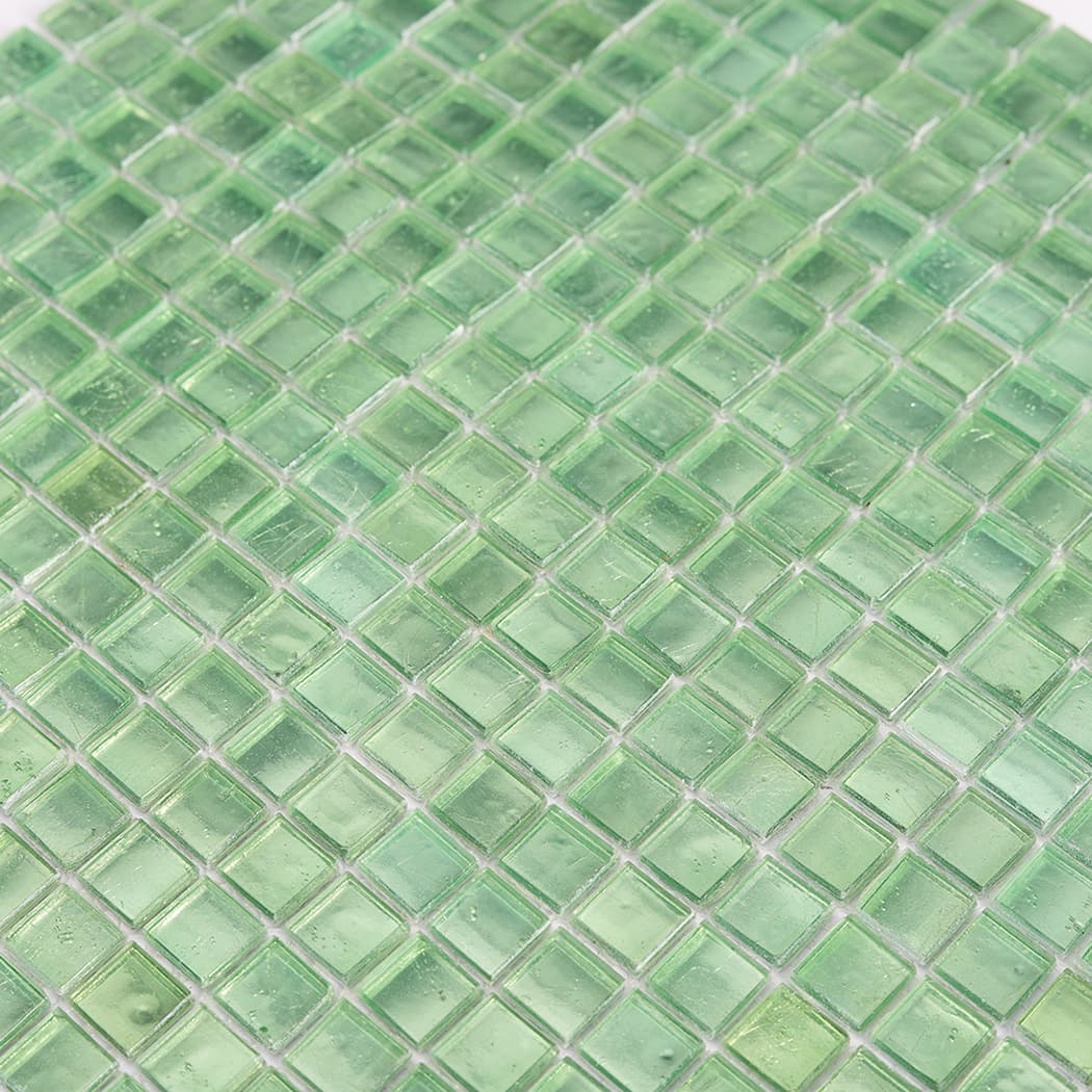 Close up view of green glass square mosaic tiles showing glossy surface texture