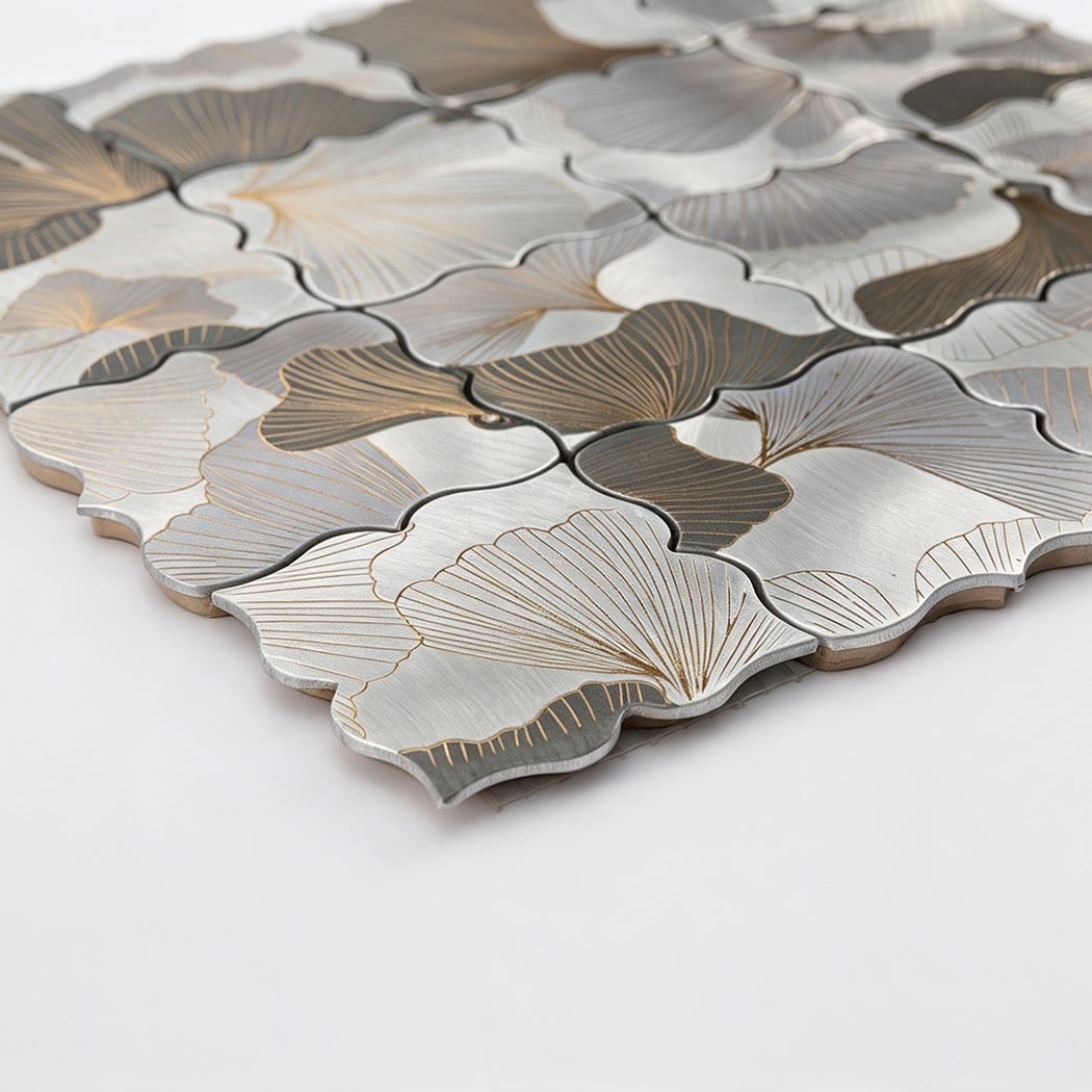 Angled close-up of grey and silver floral aluminum mosaic tile with engraved petals