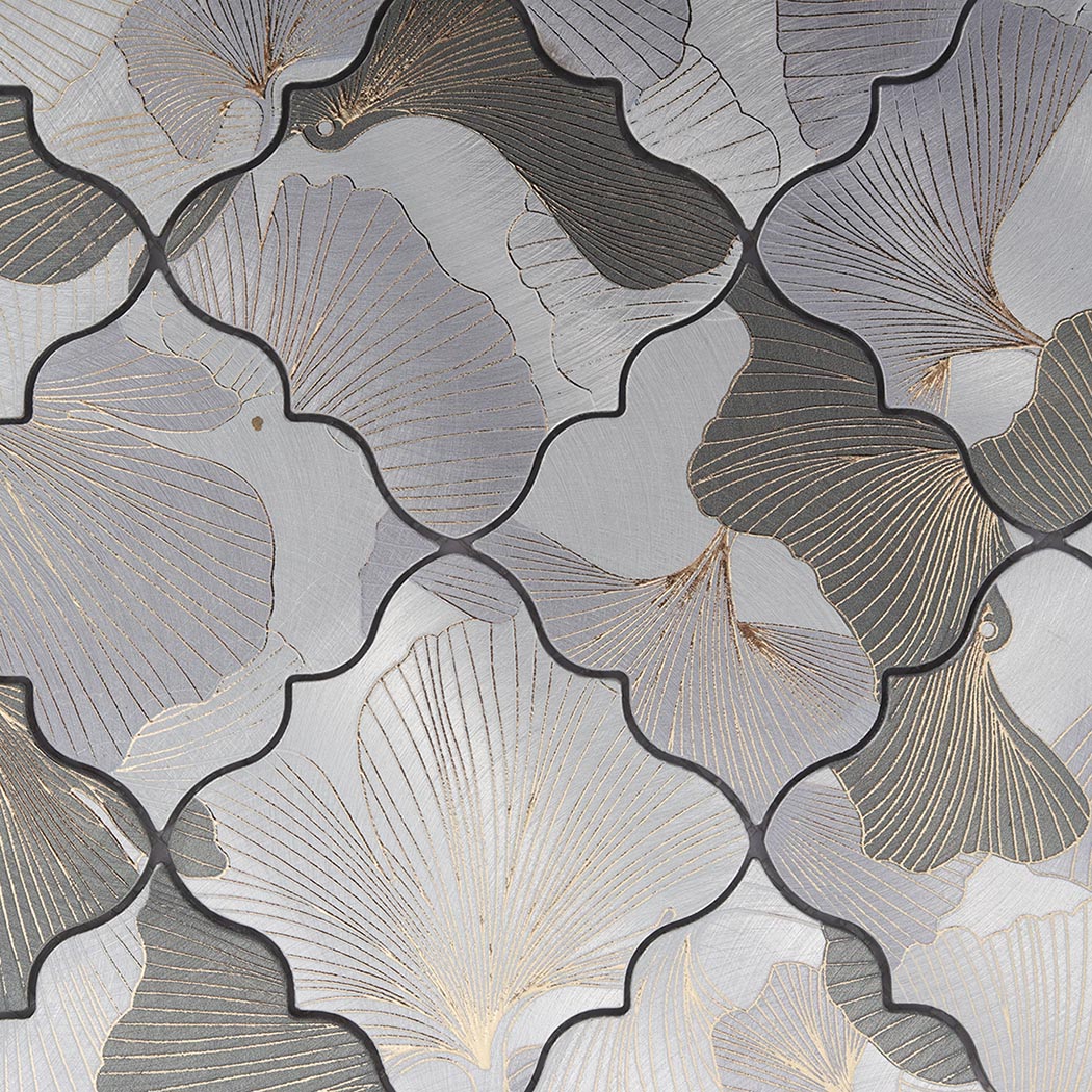Close-up of grey and silver floral aluminum mosaic tile with engraved botanical pattern