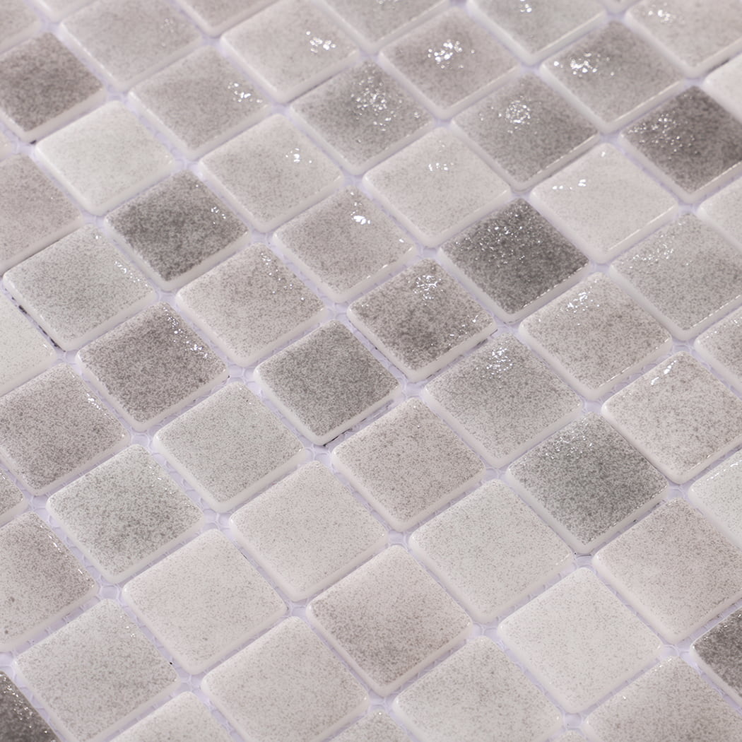 Close up of wet glossy surface on grey recycled glass mosaic tiles
