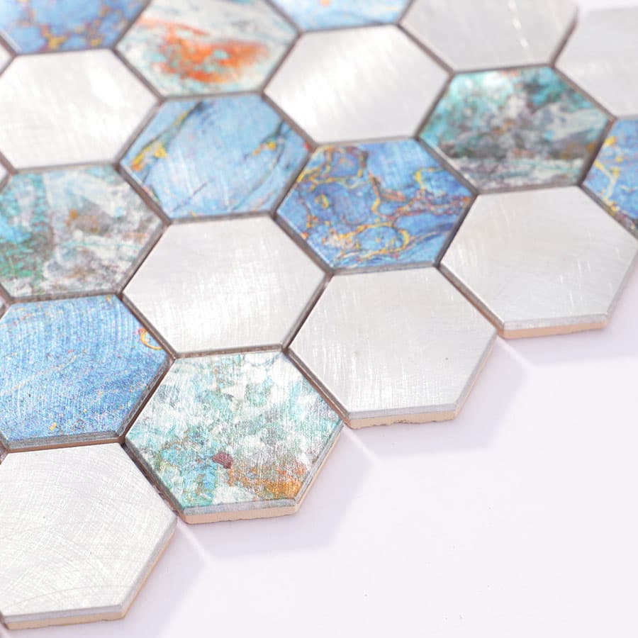 Angled edge shot of aluminum hexagon mosaic tiles showing variation in height and sheen.