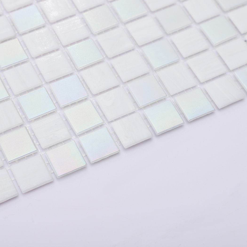 Edge detail showing thickness of iridescent white glass mosaic tiles on mesh