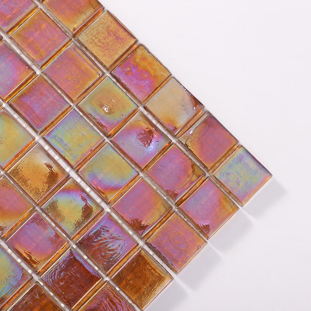 Close up of the corner of iridescent amber square glass mosaic tiles
