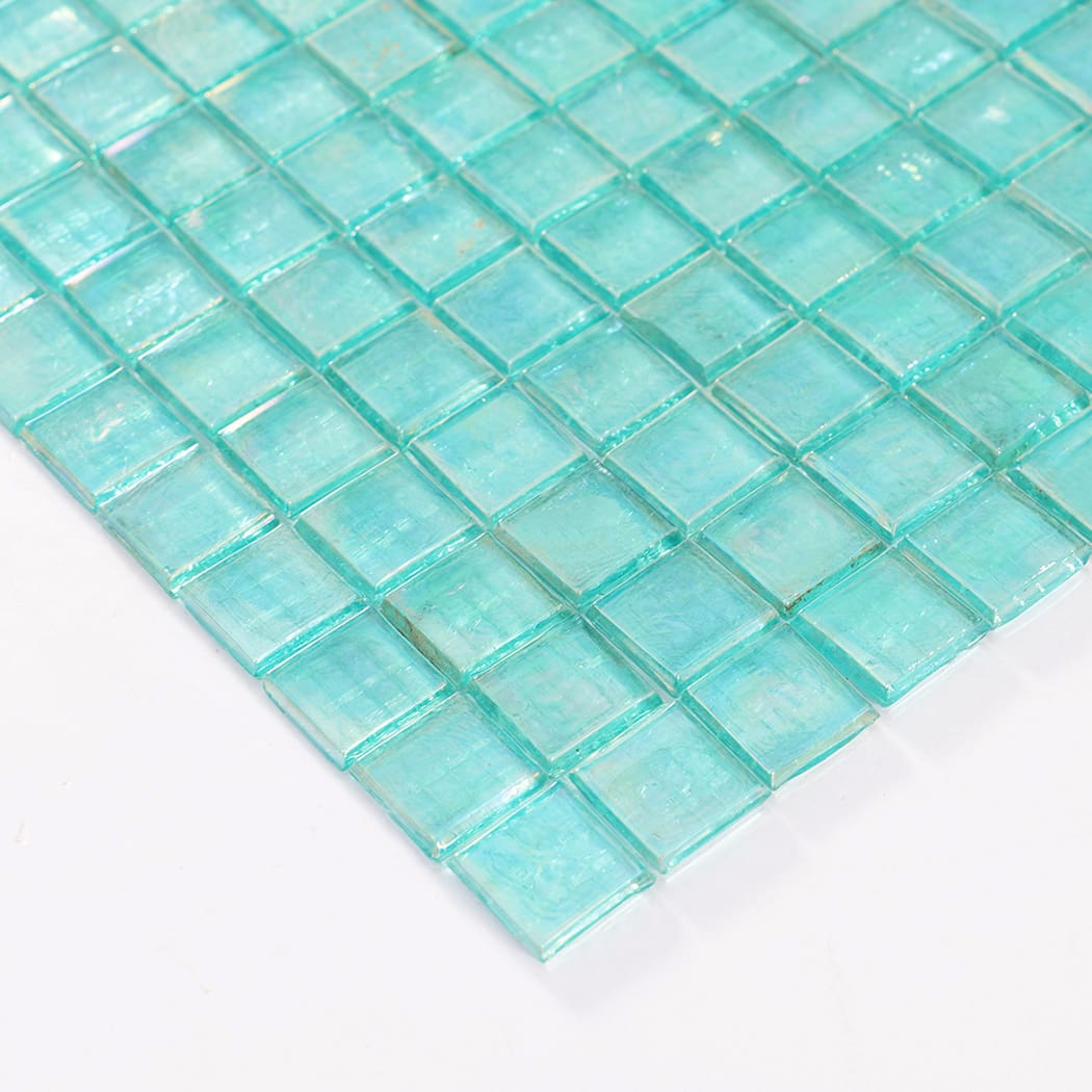 Angled view highlighting thickness and edges of aqua glass mosaic tiles.