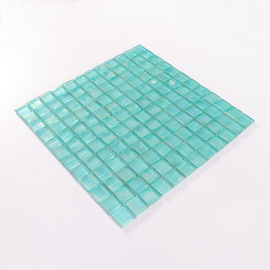 Perspective view of an iridescent aqua square glass mosaic tile sheet.