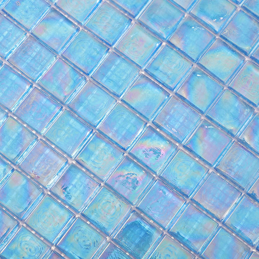 Close up of iridescent blue glass mosaic tiles showing iridescent sheen.