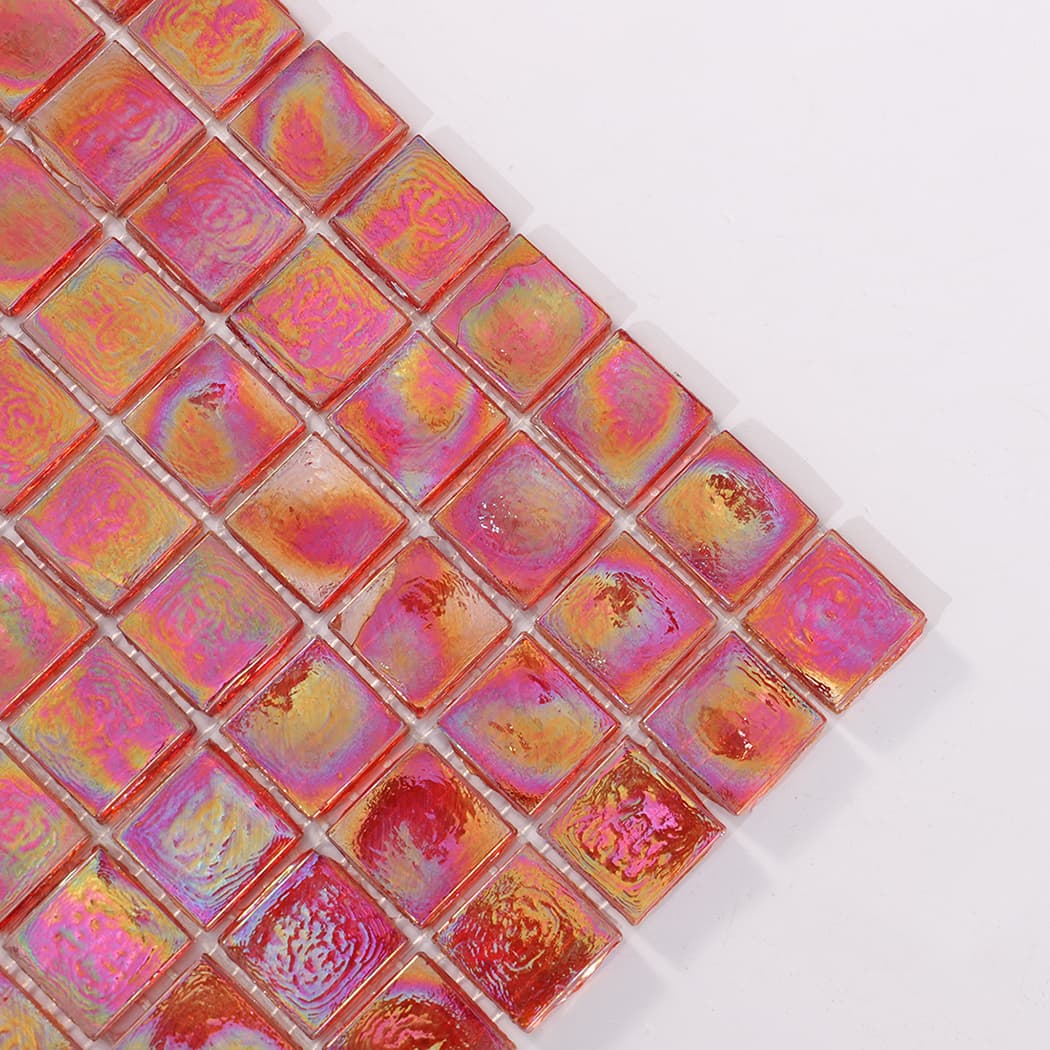 Close up of the corner of iridescent red square glass mosaic tiles.