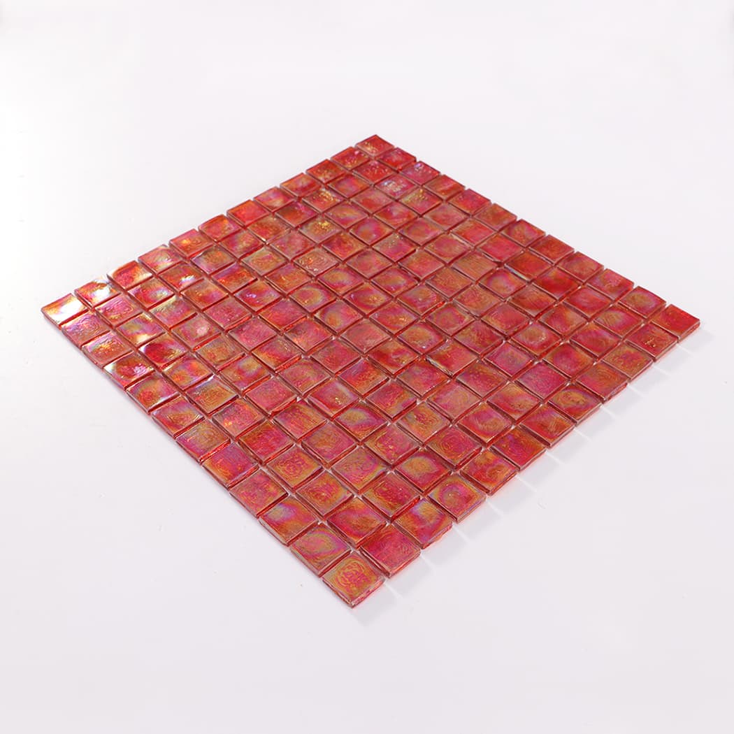 Perspective view of an iridescent red square glass mosaic tile sheet.