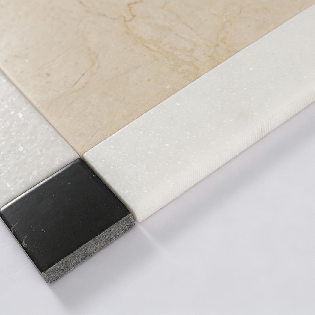 Edge detail of beige white and black marble floor tile pieces