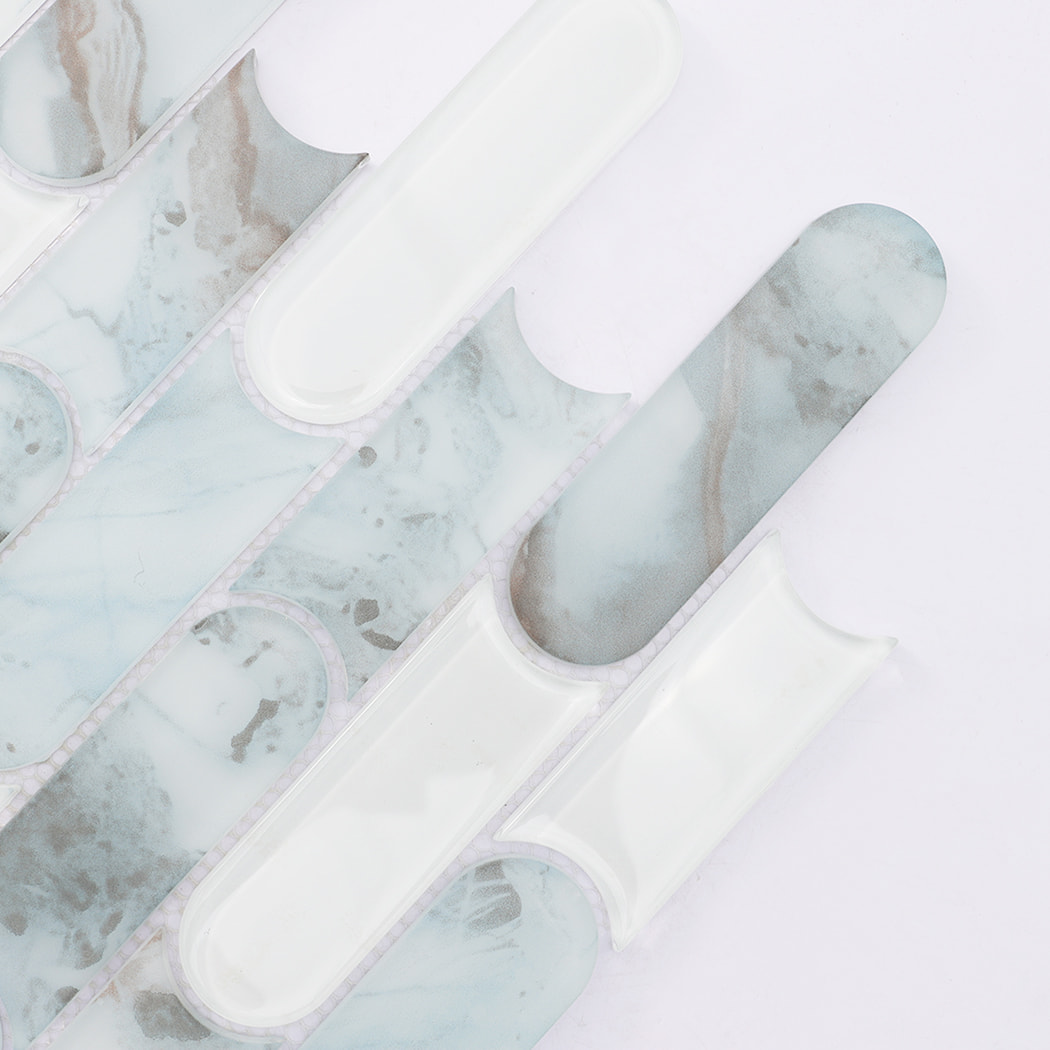 Close up of light blue beige and white pill shaped glass mosaic tile pieces