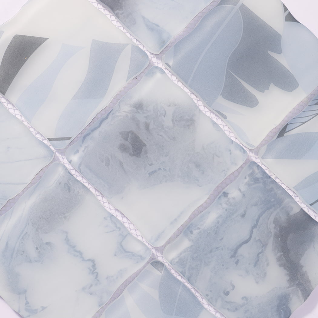 Surface detail of light blue gray wavy glass mosaic tiles with cloudy texture