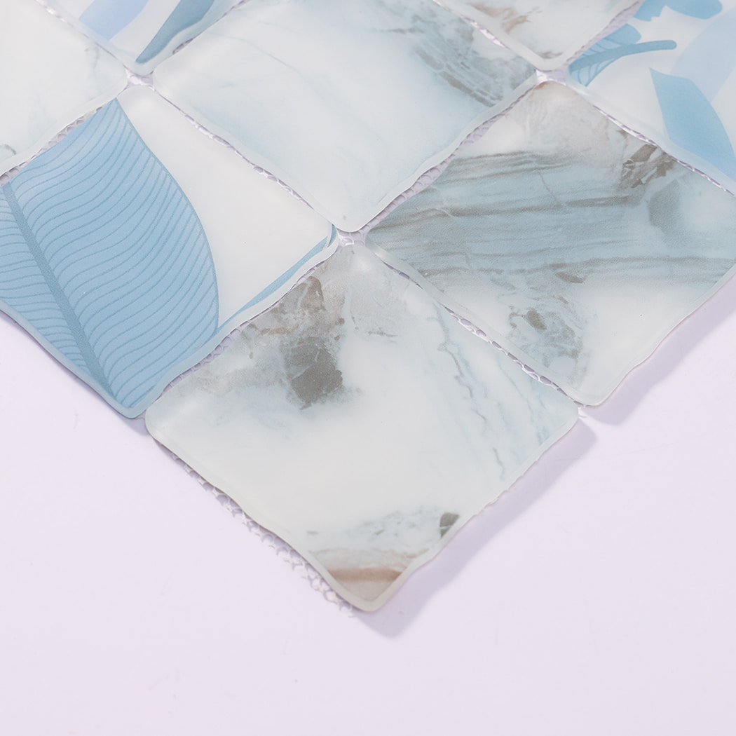 Edge detail of light blue patterned wavy square glass mosaic tiles