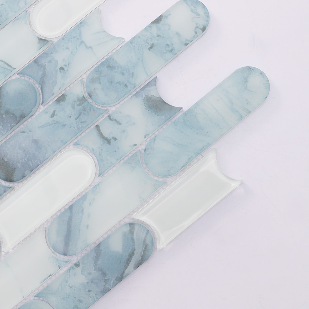 Close up of light blue patterned and white rounded linear glass mosaic tiles