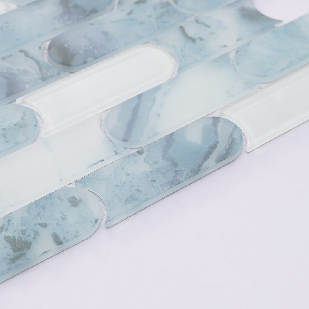 Detailed view of light blue and white rounded linear glass mosaic tile pattern