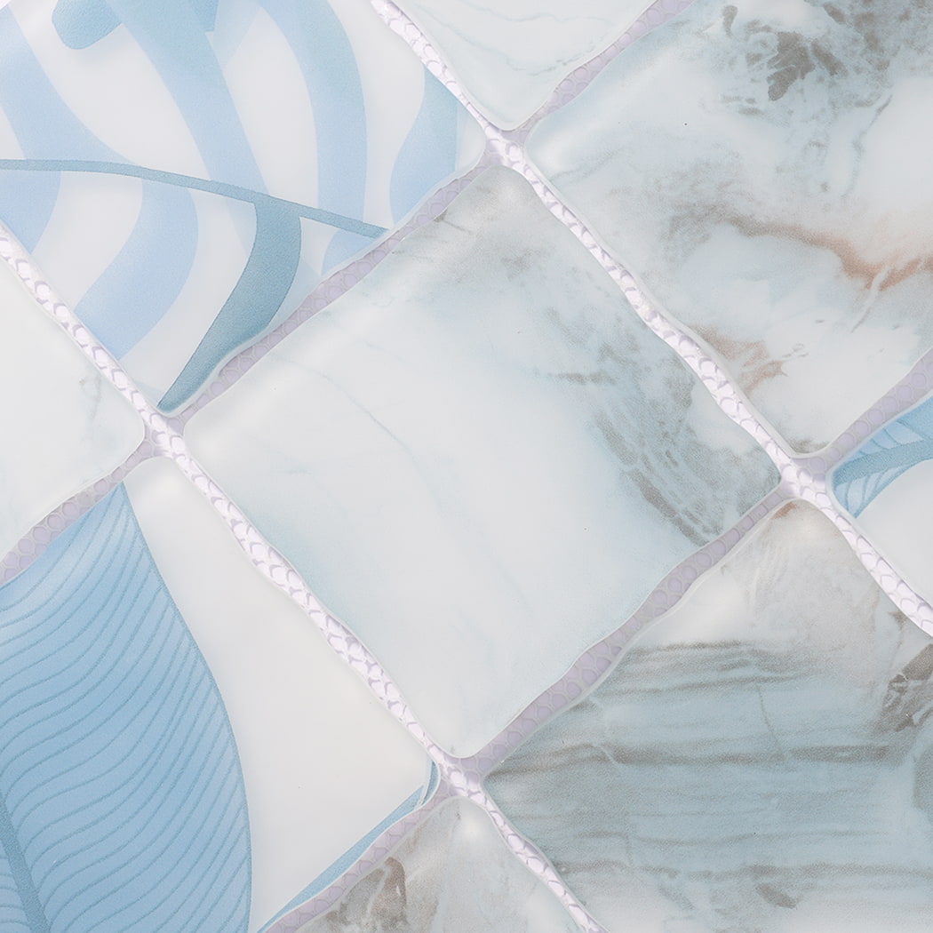 Surface detail of light blue white wavy glass mosaic tiles with marble patterns