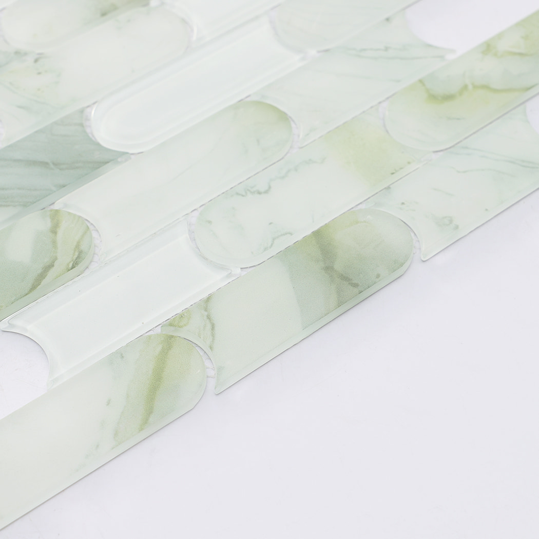 Close up of light green marble and white glass mosaic with rounded linear pieces