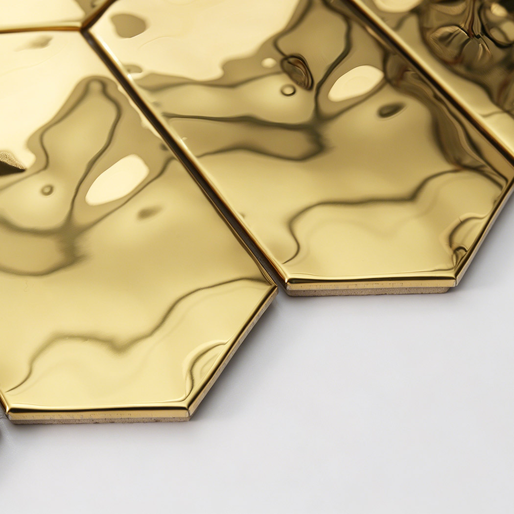 Macro view of reflective gold hexagon stainless steel tile with fluid texture