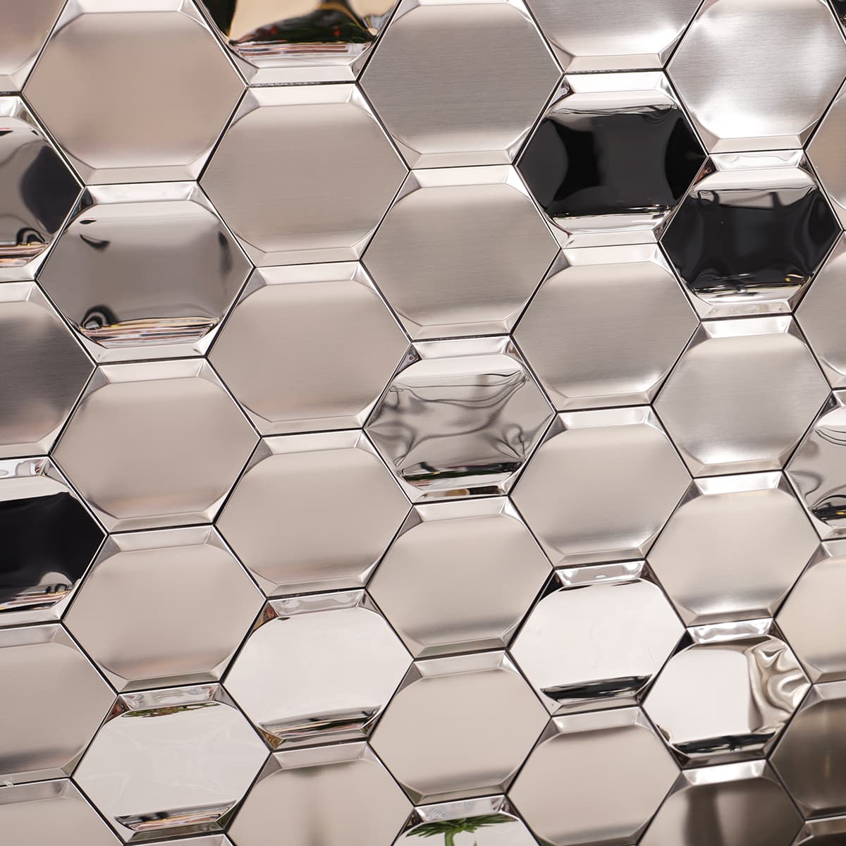 Macro shot of brushed and mirror finish silver hexagon stainless steel tiles.