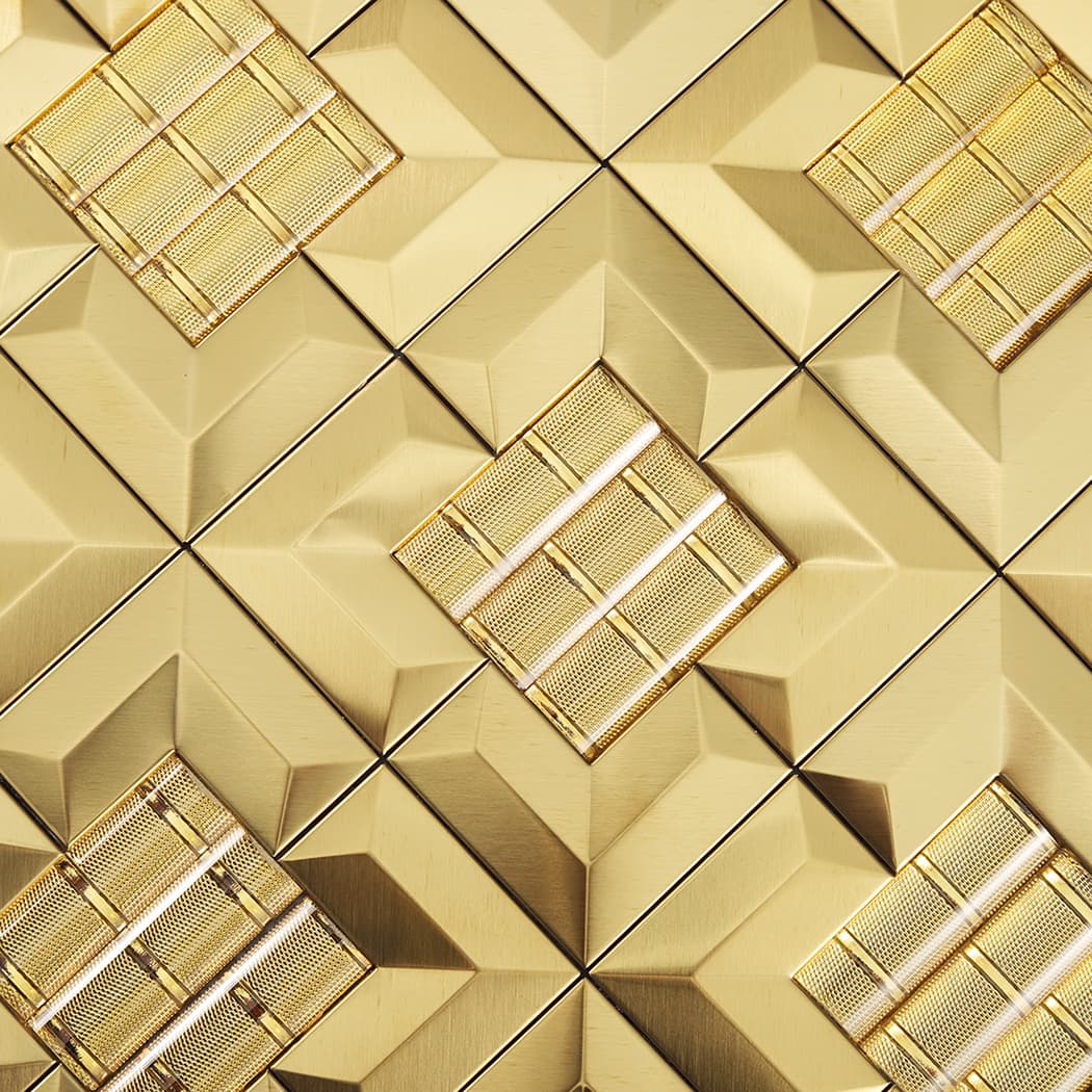 Macro view of a gold 3D metallic tile focusing on the intricate textured square surface.
