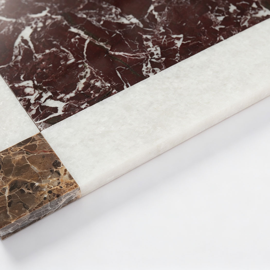Brown marble corner accent detail on burgundy and white border mosaic tile