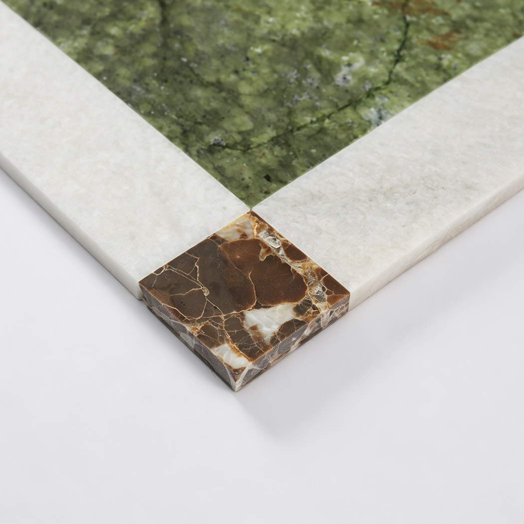 Brown marble corner accent detail on green and white border mosaic tile