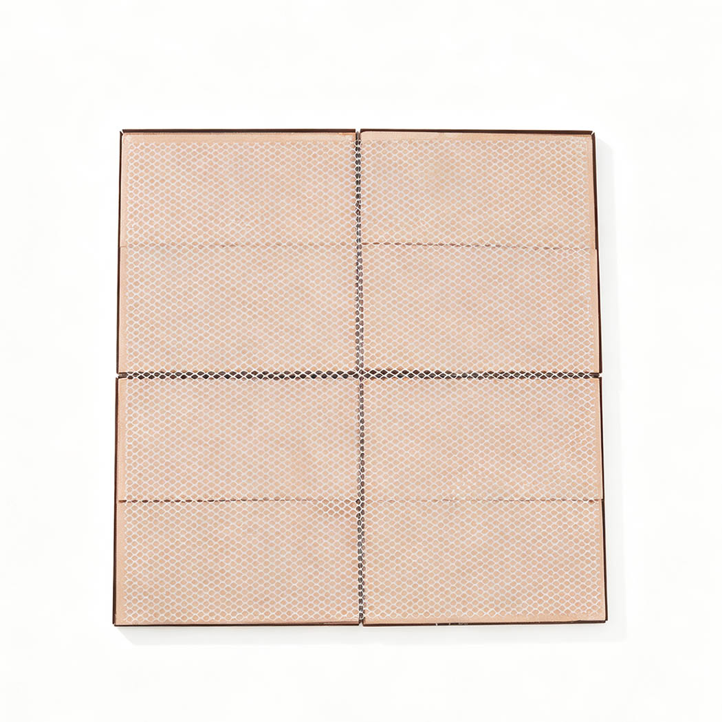 Back view of four copper square mosaic tiles mounted on white mesh backing