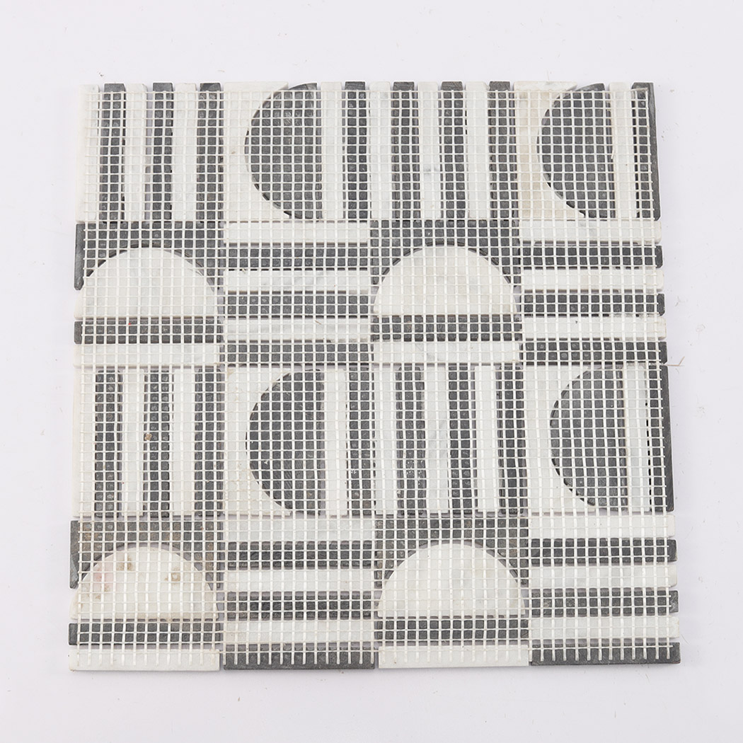 Back view of the black and white marble mosaic tile showing the fiberglass mesh.