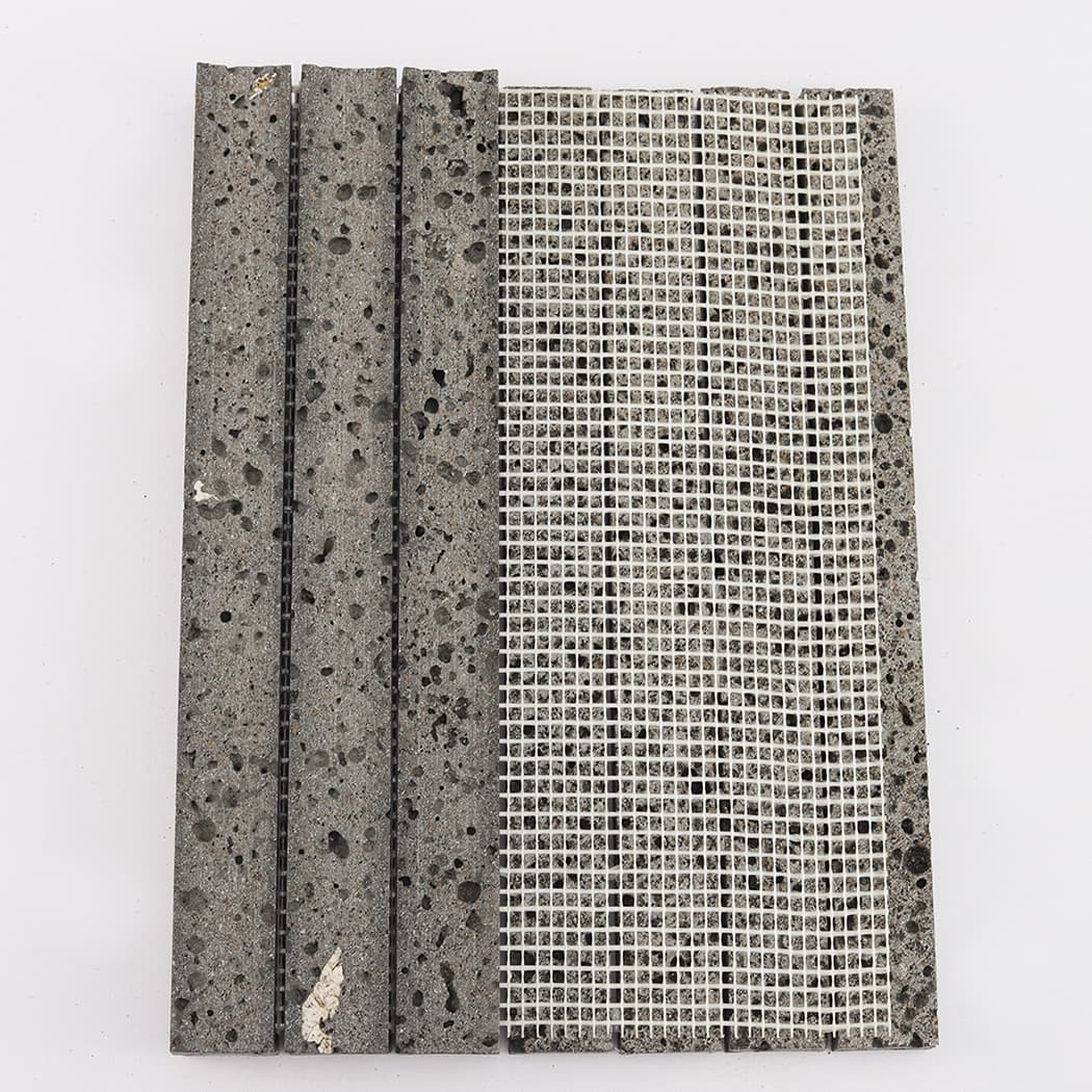 Rear view showing the white mesh mounting of the lava stone mosaic tile sheet.