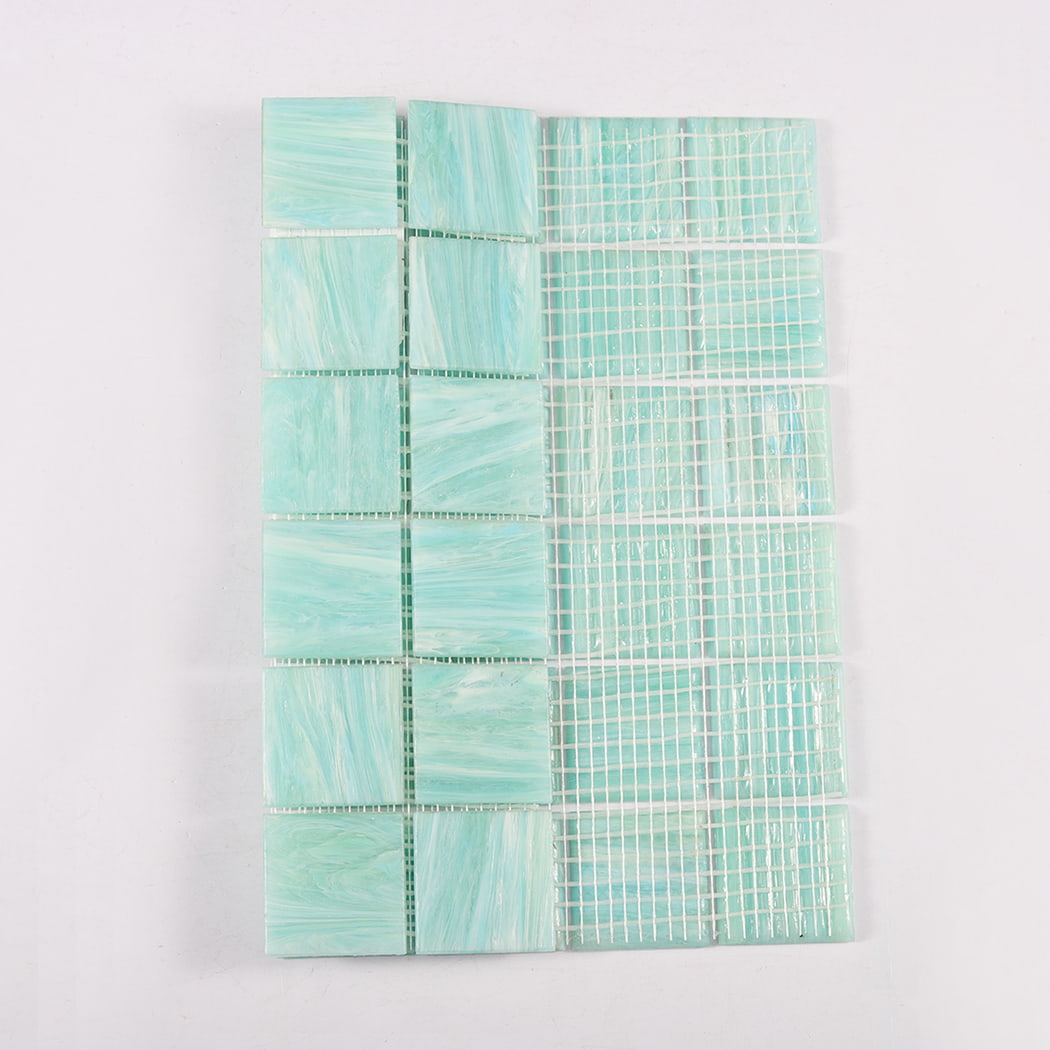 Mint green glass mosaic sheet showing tile face beside backing grid side