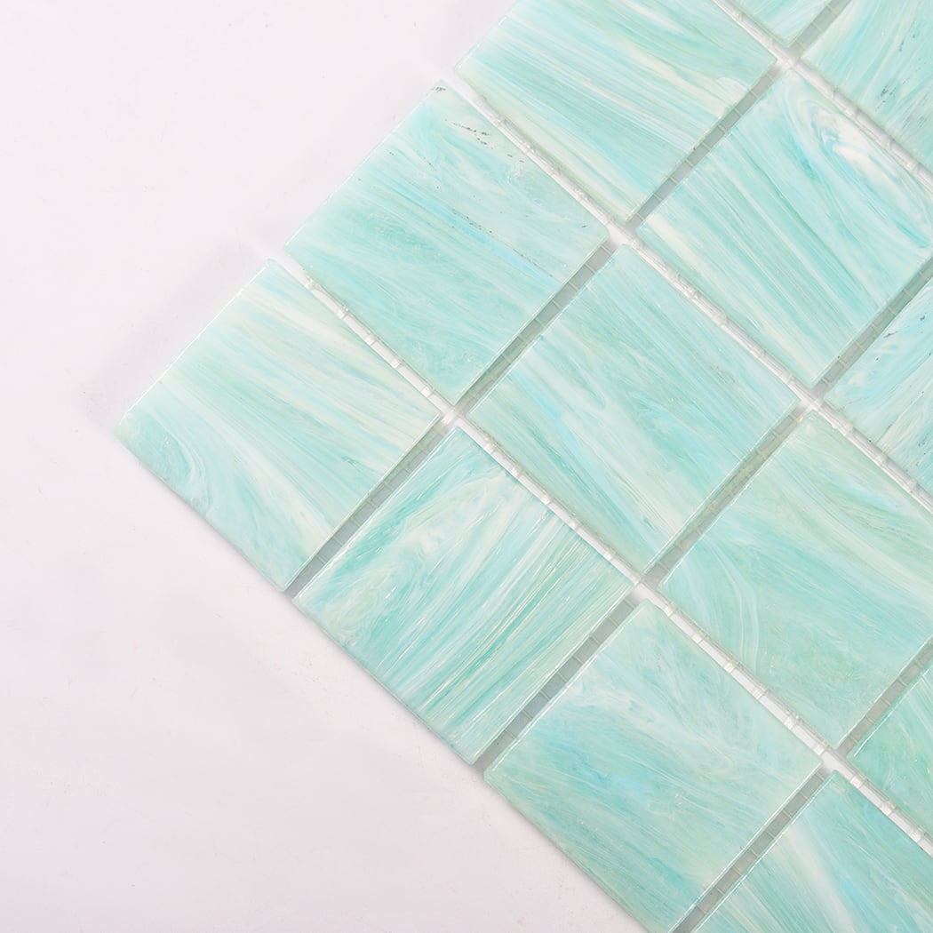 Corner closeup of mint green glass mosaic tiles with soft marbled swirls