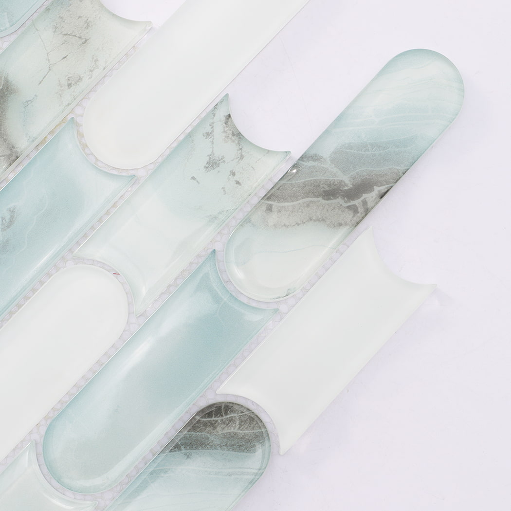 Close up of mint green and white interlocking pill shaped glass mosaic tiles