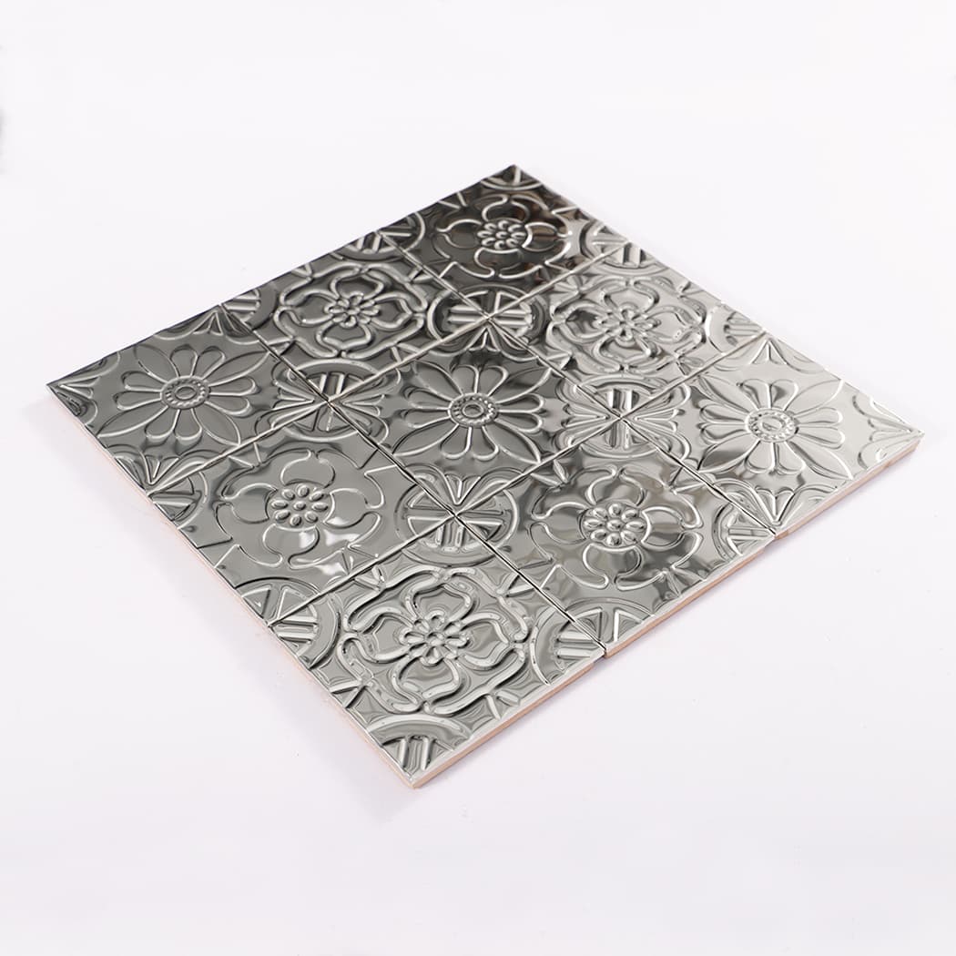 Angled display of mirror silver embossed mosaic highlighting glossy shine and patterned relief.