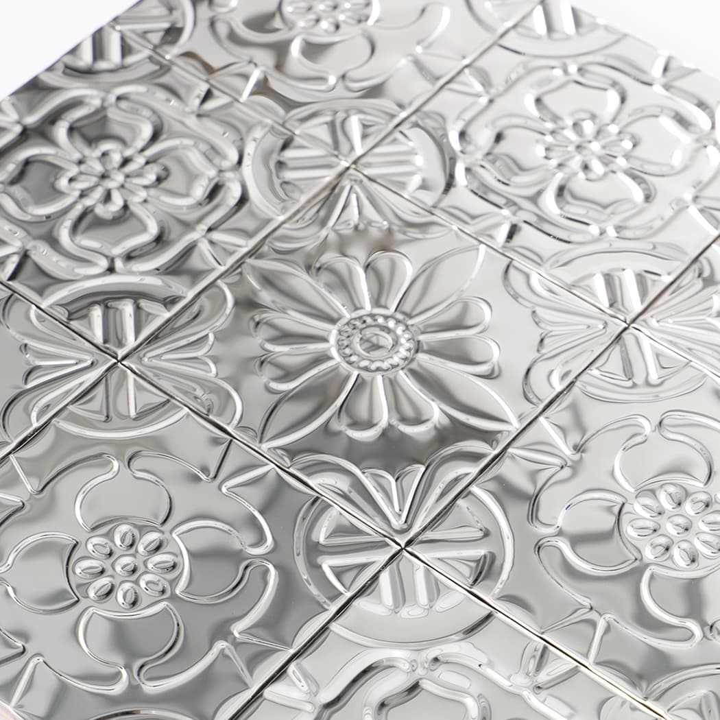 Detailed view of mirror silver mosaic showing alternating floral patterns with raised 3D texture.