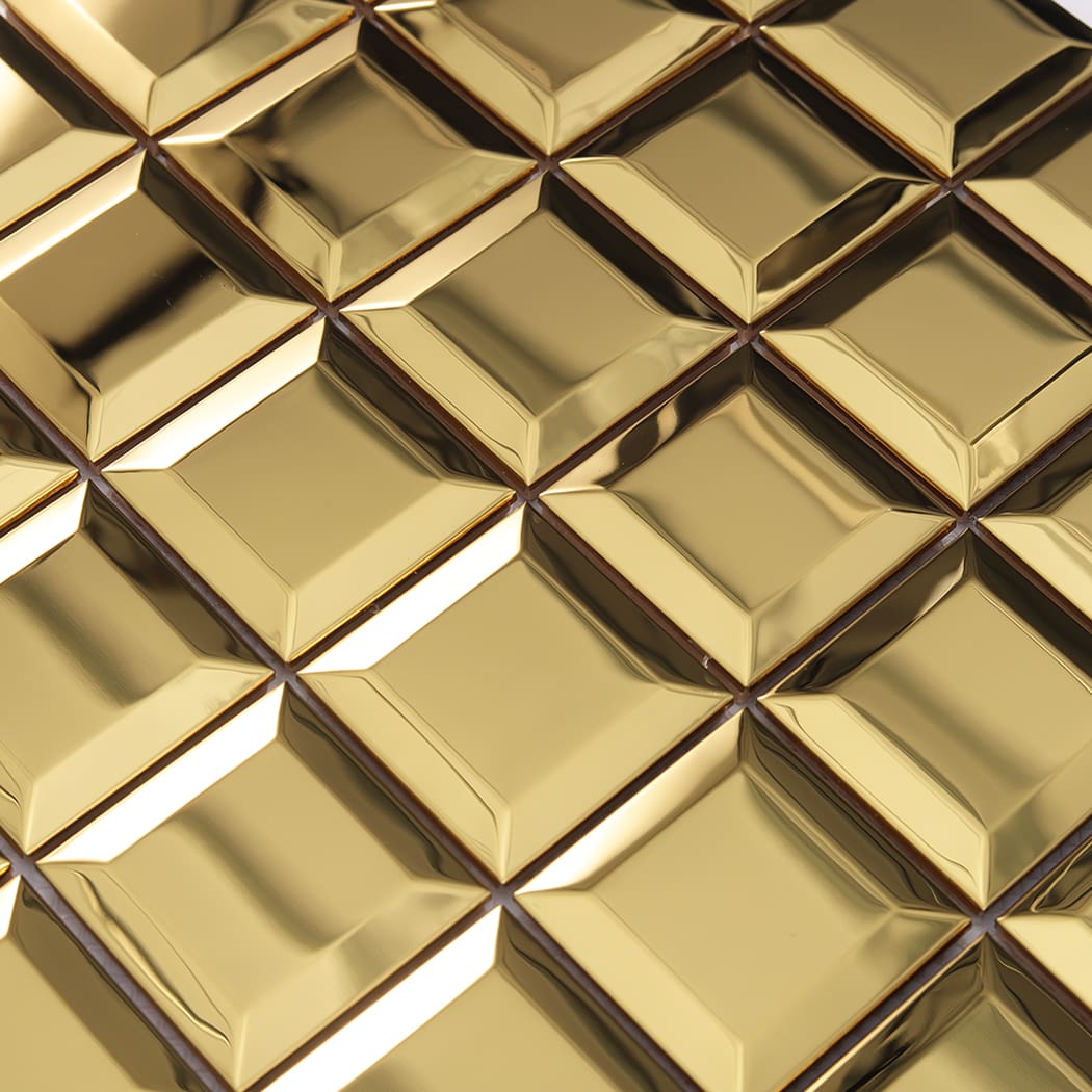 Detailed close up of mirror gold beveled stainless steel mosaic tile surface and edges