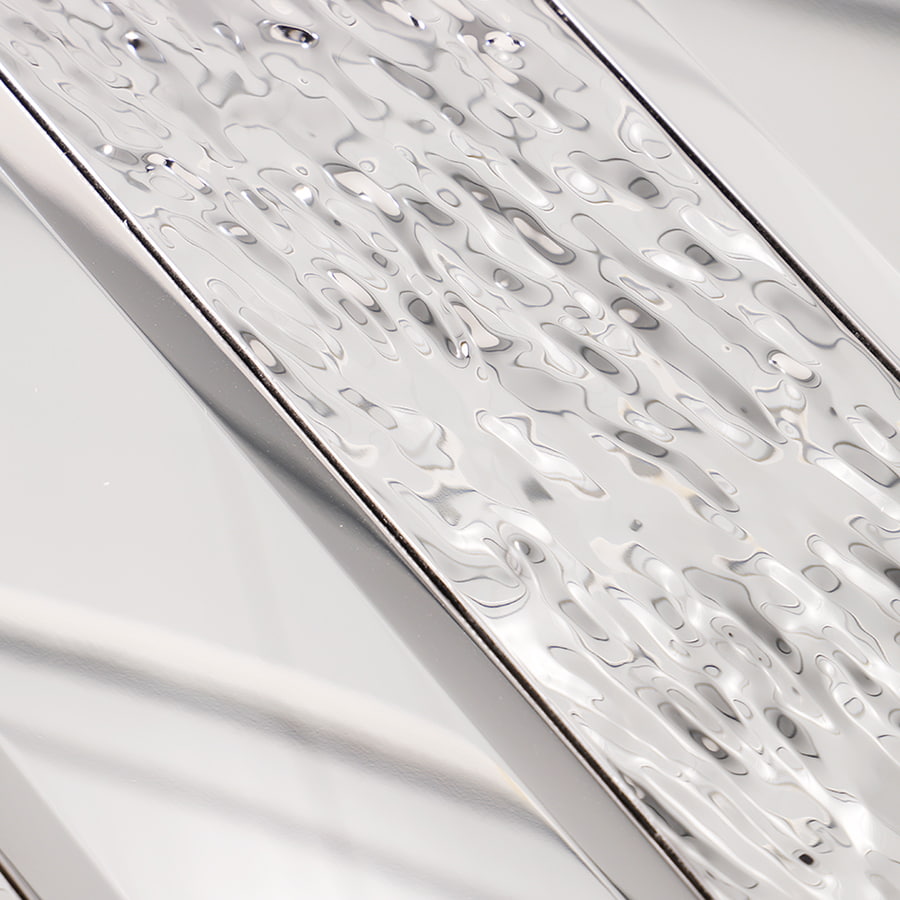 Detailed view of mirror silver rectangle tile with hammered and reflective surface