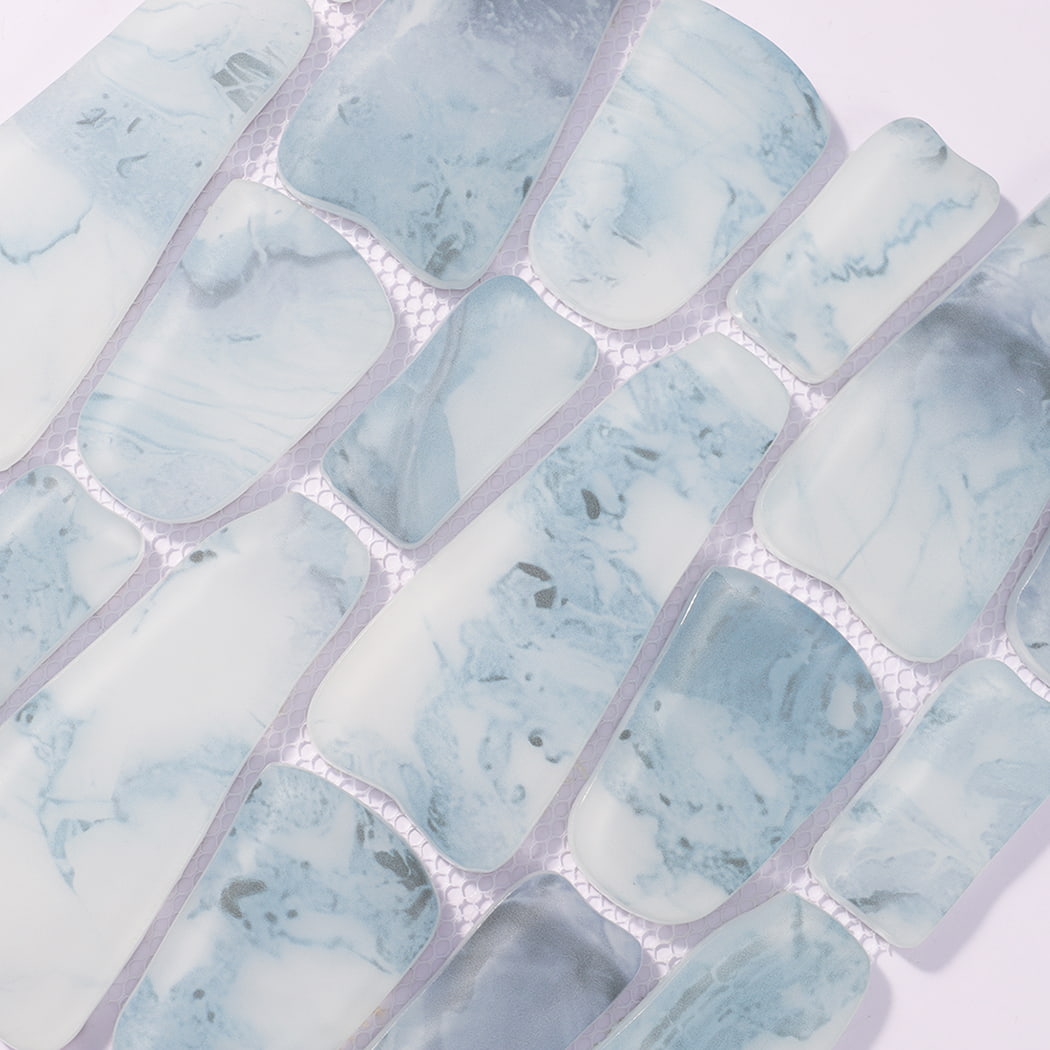 Detailed view of misty blue irregular glass mosaic tiles on mesh backing