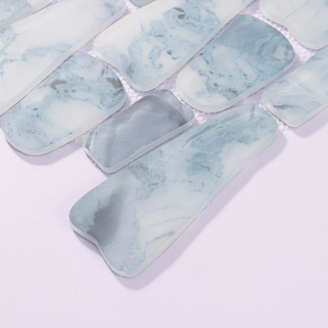 Angled view of misty blue pebble glass tiles with smooth rounded edges