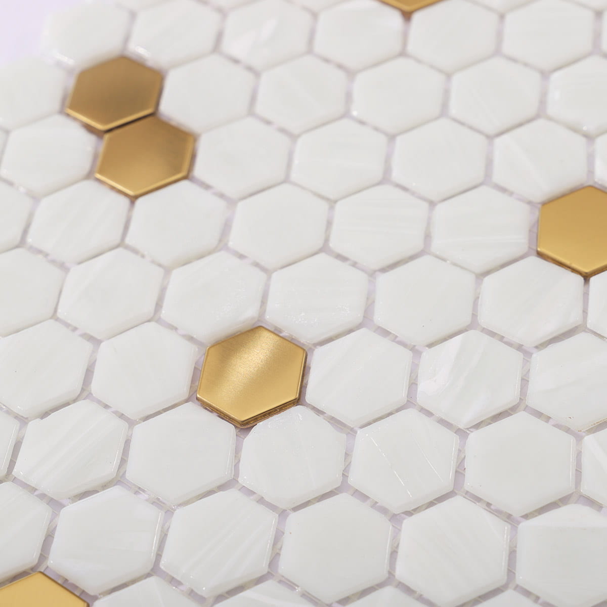 Golden Accents in White Tiles – Chic white hexagon tiles with gold metal accents
