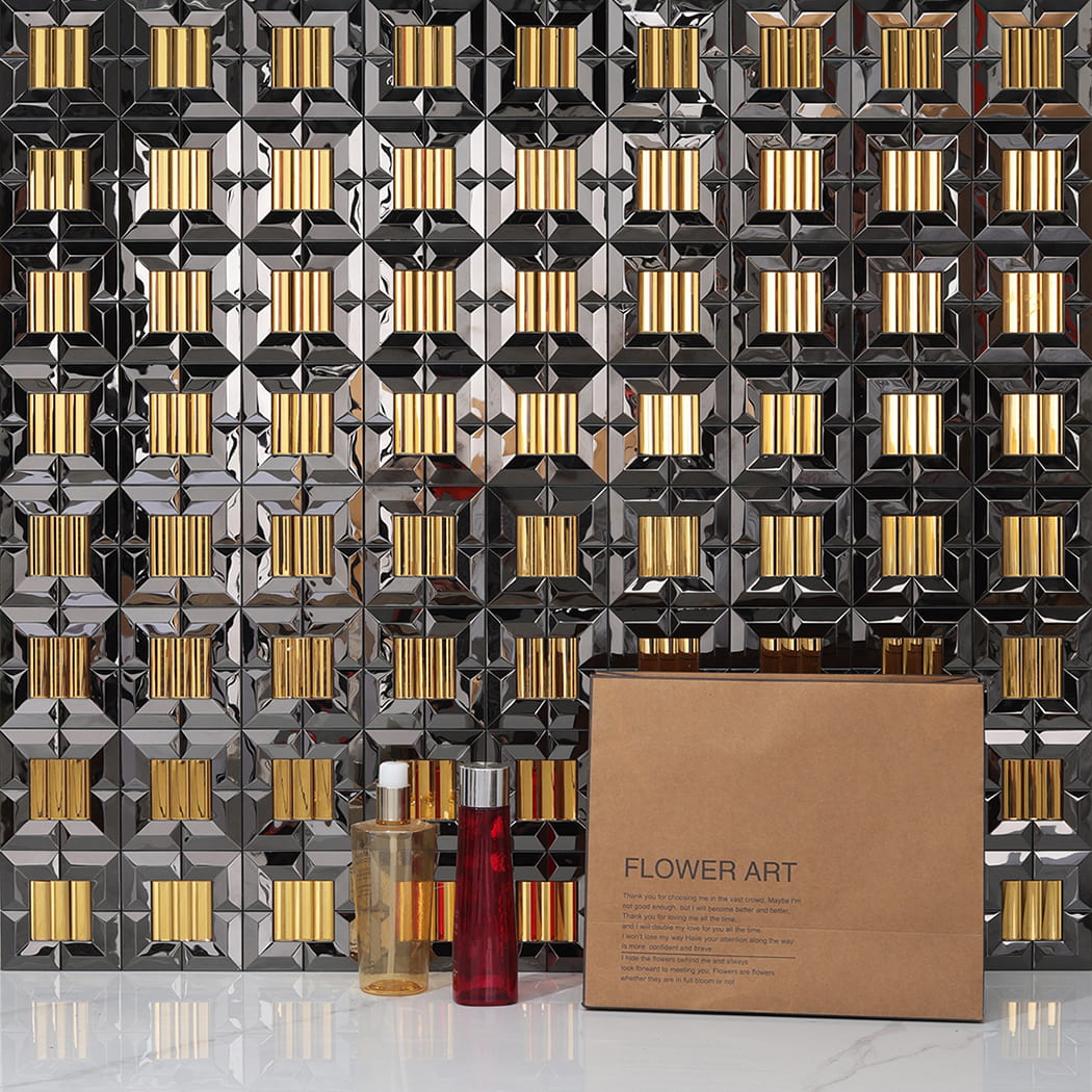 Mirror mosaic tiles installed on a wall behind cosmetic bottles and a gift box.