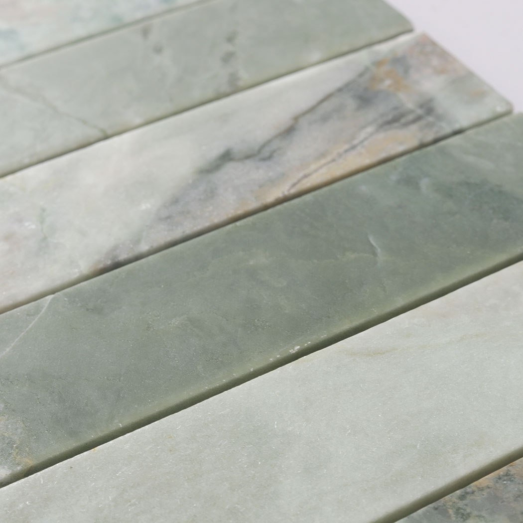 Detailed view of green marble strip tiles showing smooth finish and color variation
