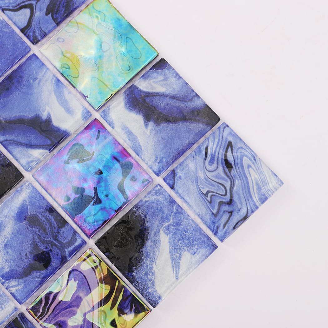 Corner detail of navy blue iridescent square glass mosaic tiles with marbled patterns