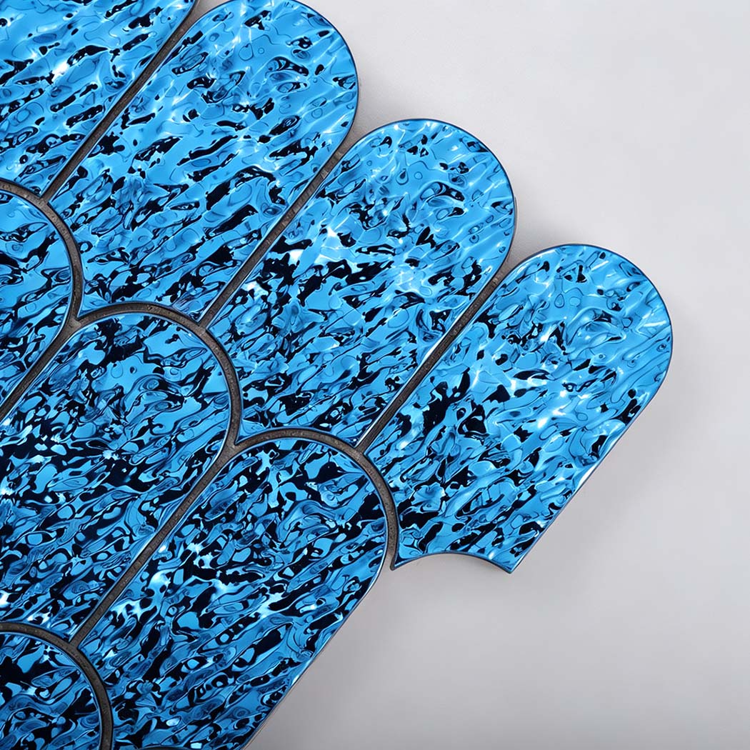 Close-up of glossy ocean blue ripple scallop mosaic tile texture