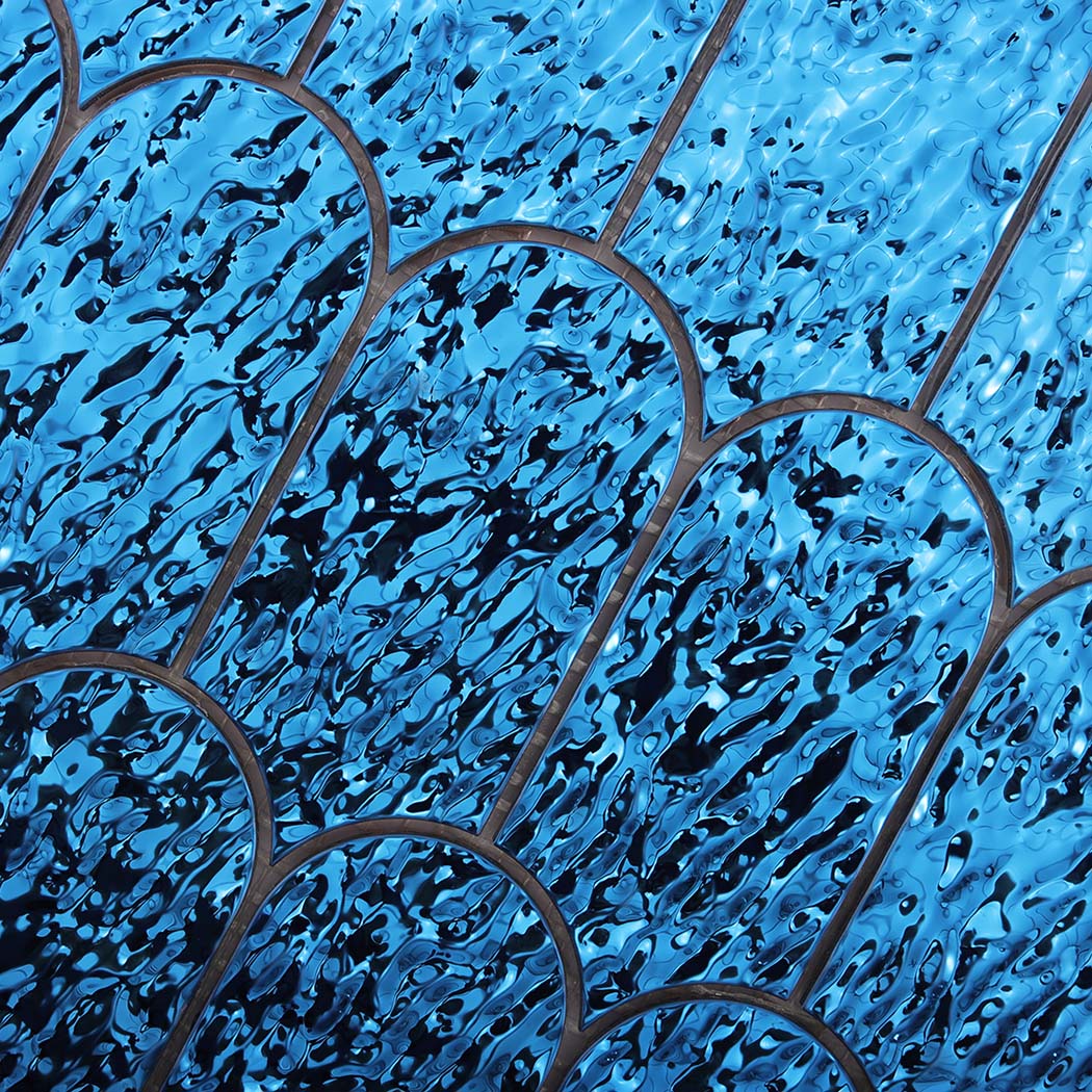 Detailed view of reflective ocean blue ripple scallop mosaic tiles