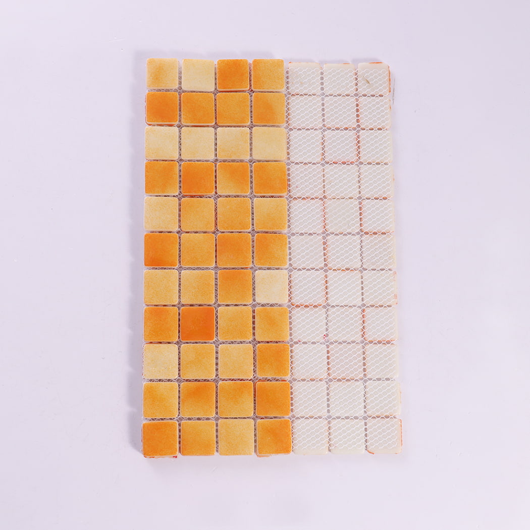 Backside view of orange recycled glass mosaic tile sheet with mesh backing